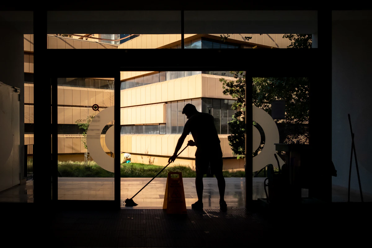 Commercial cleaner cleaning an office entrance